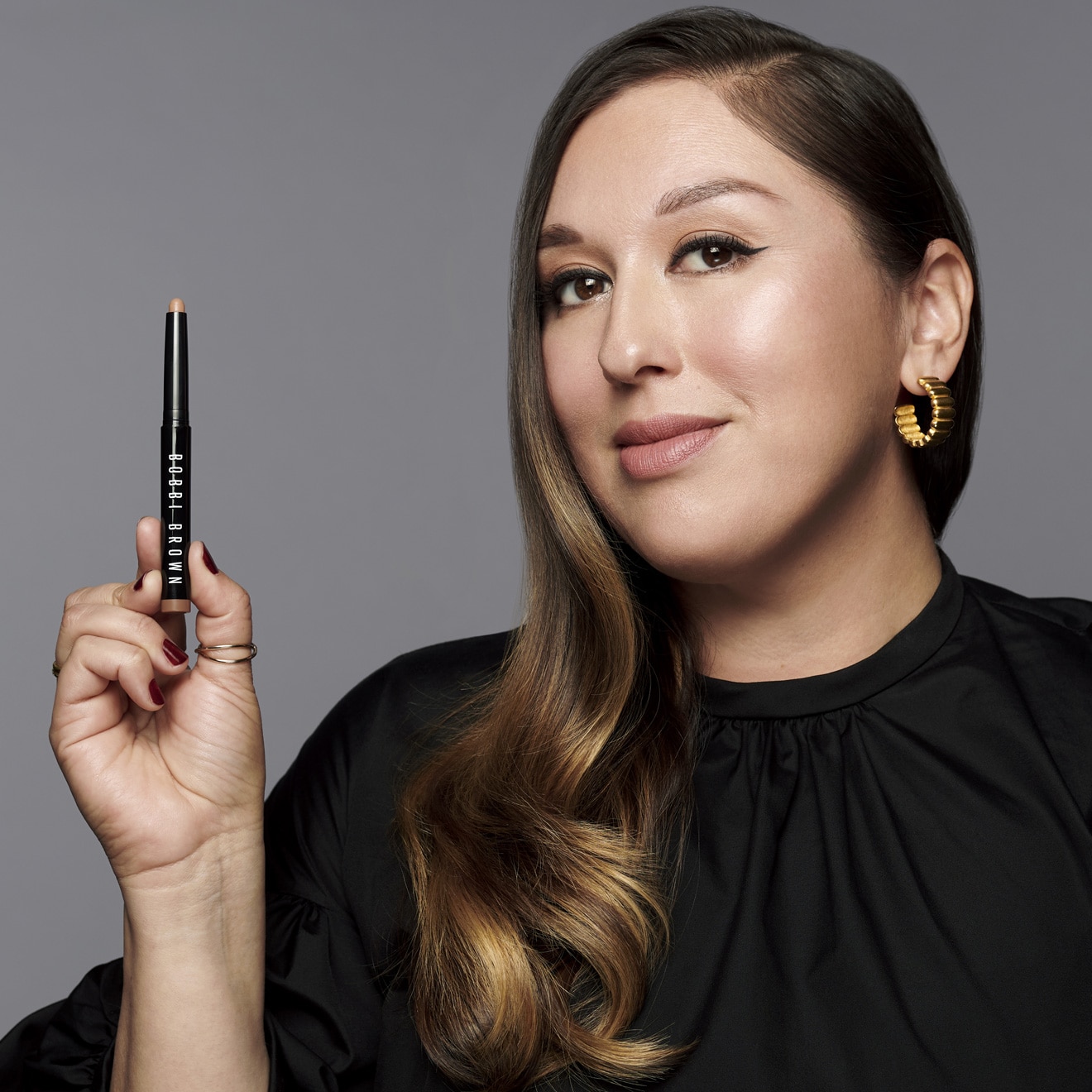 Bobbi Brown Pro Artist, Cassandra, holding our bestselling Long-Wear Cream Shadow Stick